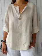 Elegant linen blouse featuring a flattering V-neckline and stylish roll tab sleeves, perfect for casual or dressy occasions. 1