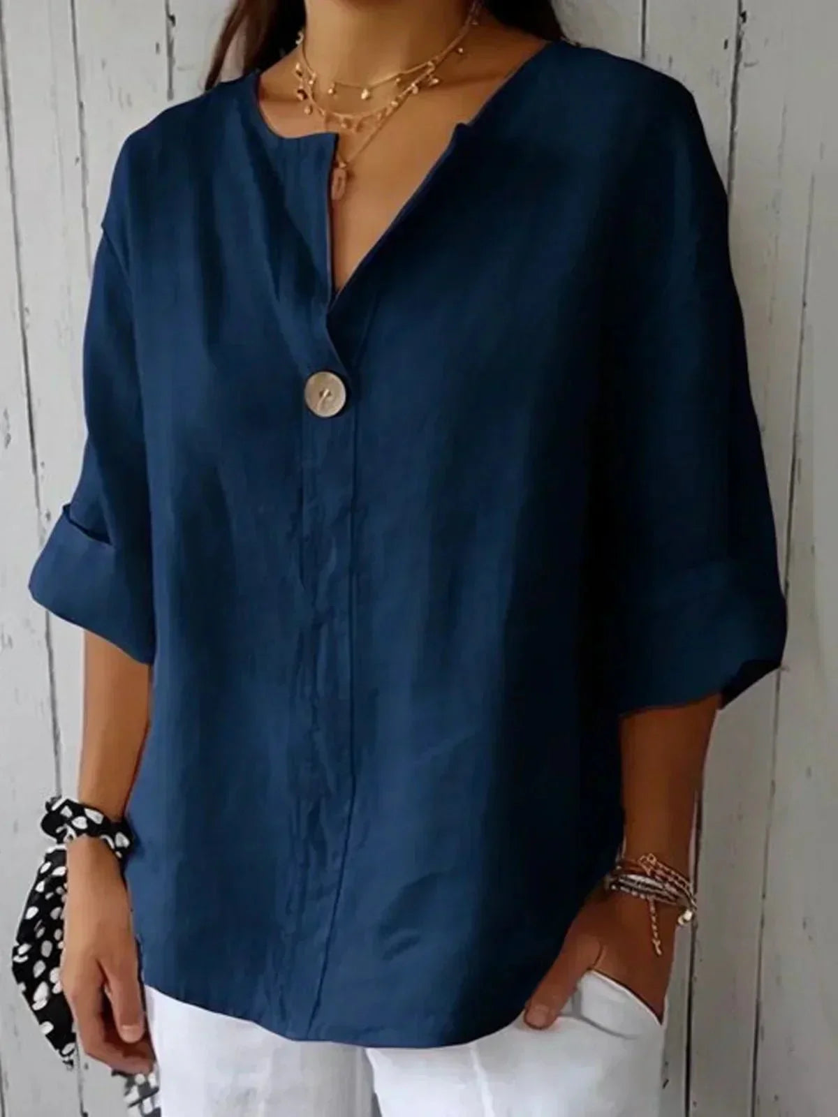 Elegant linen blouse featuring a flattering V-neckline and stylish roll tab sleeves, perfect for casual or dressy occasions. 6