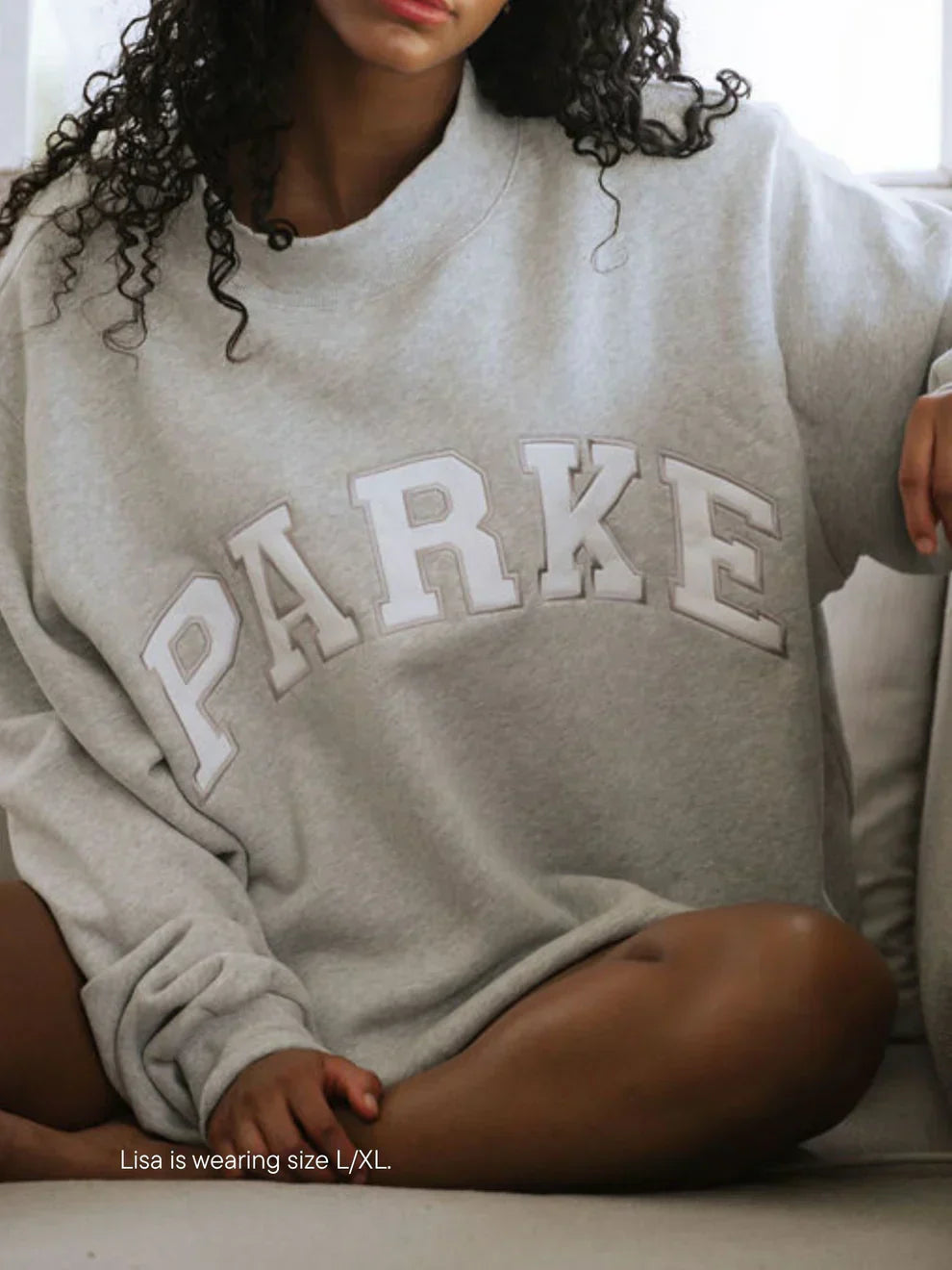 Women's oversized sweatshirt featuring soft chenille lettering, perfect for casual everyday wear and stylish comfort. 9
